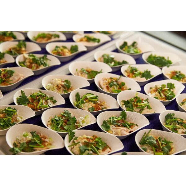 Compostable Taster Cups filled with salad arranged on a purple table