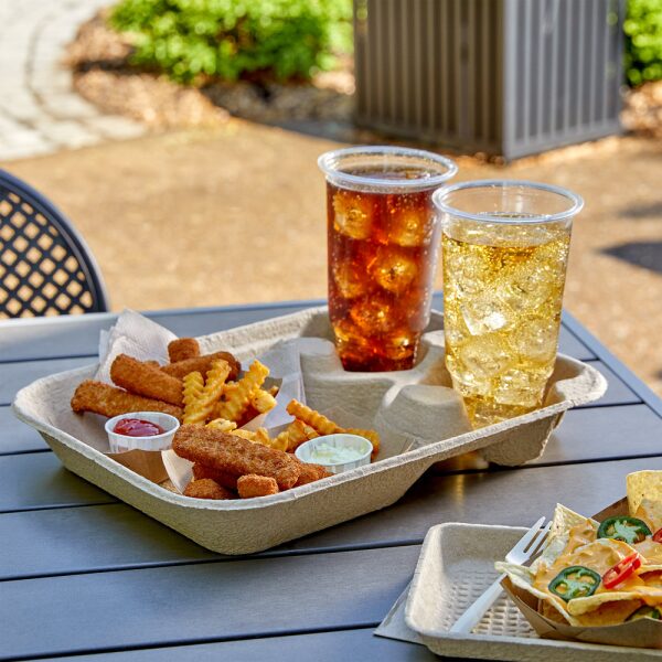 Compostable cold cups filled with drinks served with fries in a disposable plate on a wooden table.