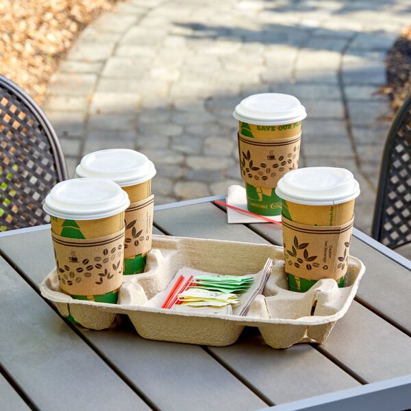 Compostable cups in a cup holder on a wooden table.