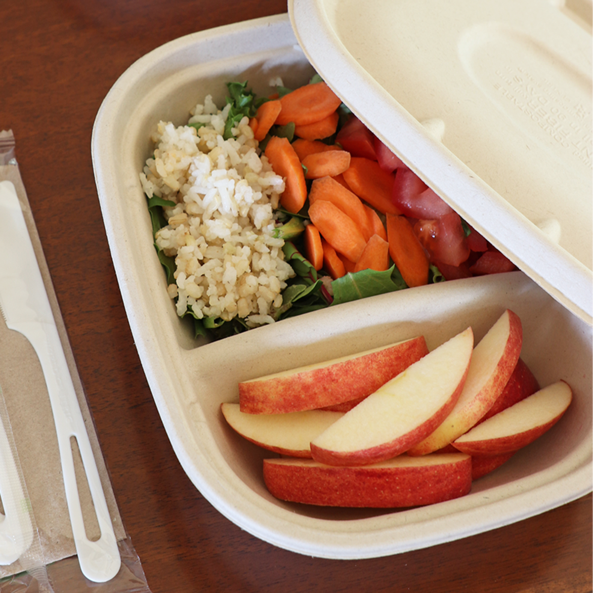 Fiber Food Container Containing Rice, Apples, and Vegetables.